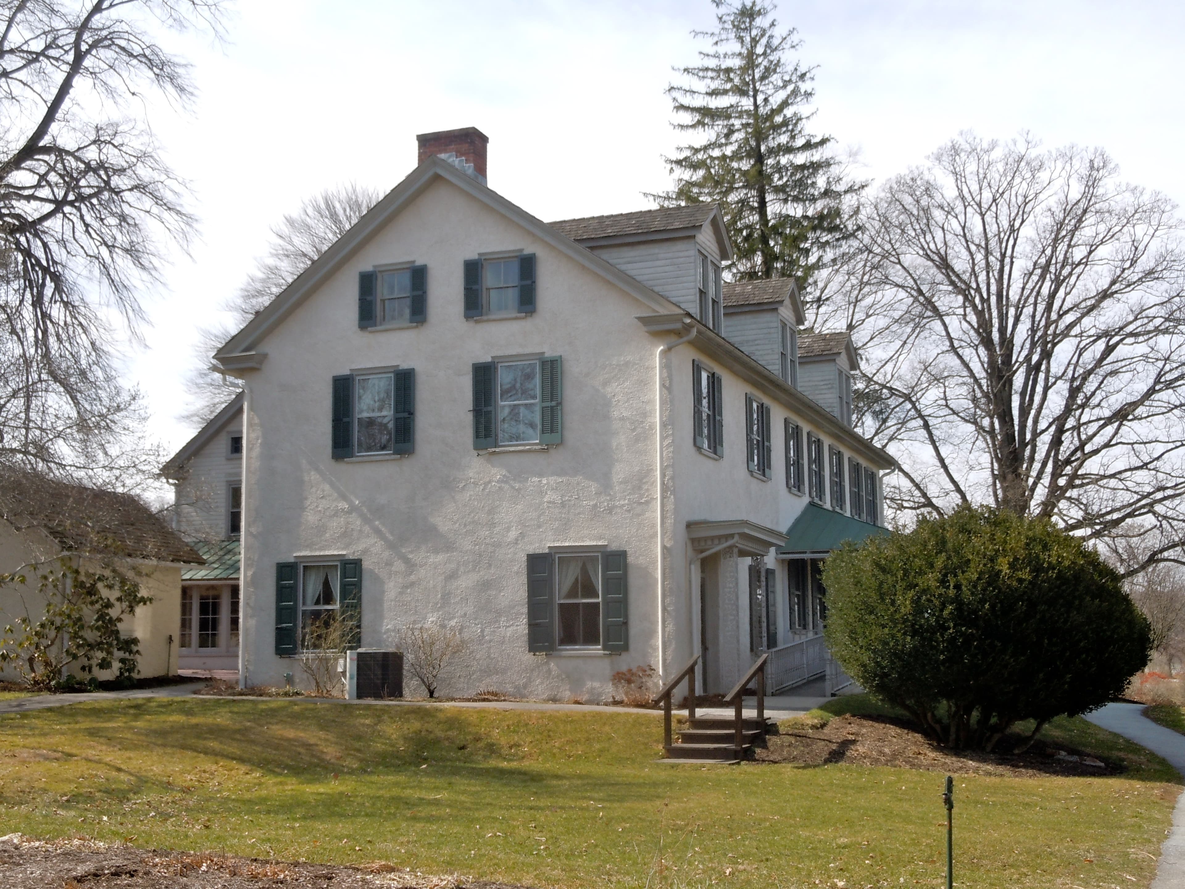 White manor house with green shutters at Springton Manor Farm