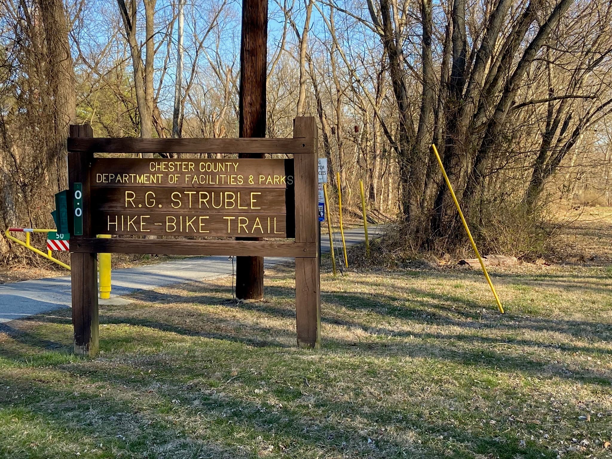 Wooden Struble Hike-Bike Trail sign at the paved Norwood Road entrance
